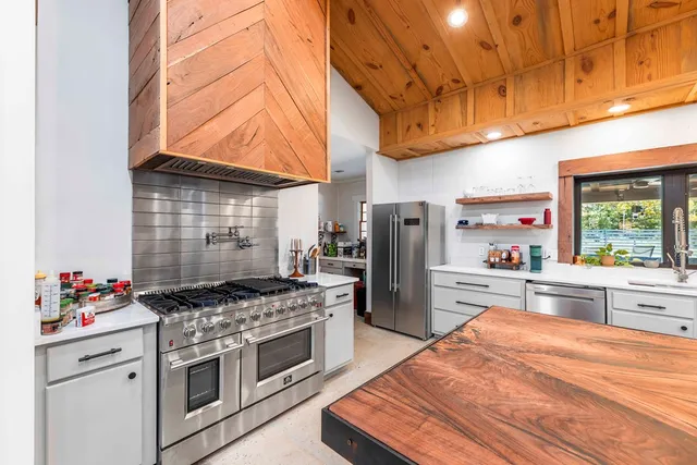 a spacious bathroom with a double vanity sink a mirror and a bathtub