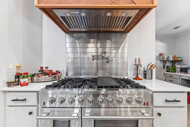 a bathroom with a white tub shower and window