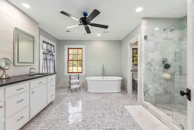 a bedroom with a bed a dresser and a window