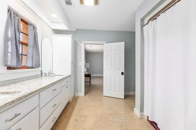 an empty room with closet and a chandelier fan