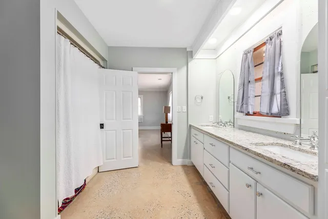a living room with furniture a large window and chairs