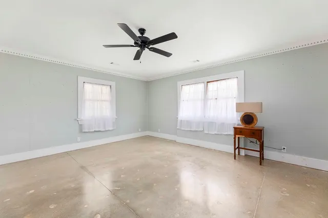 a living room with furniture a wooden floor and a large window