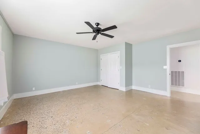 a bathroom with a granite countertop toilet and a sink