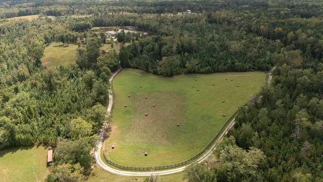 a view of garage with a car parked in front of it