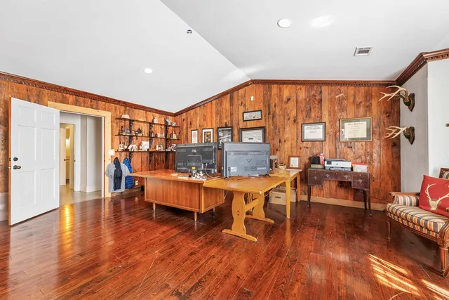 a view of pool with lawn chairs under an umbrella