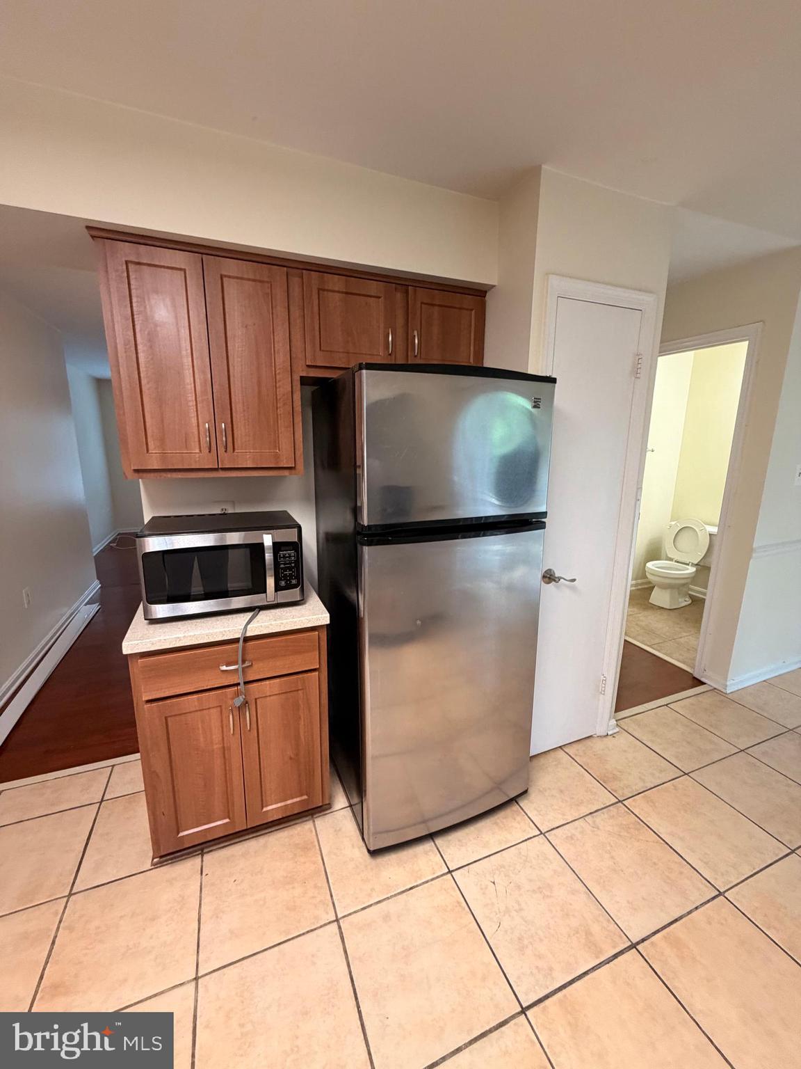 8818 Ridge Hollow Court Springfield, VA 22152 - Photo 12 of 32 a kitchen with stainless steel appliances granite countertop a refrigerator stove and sink