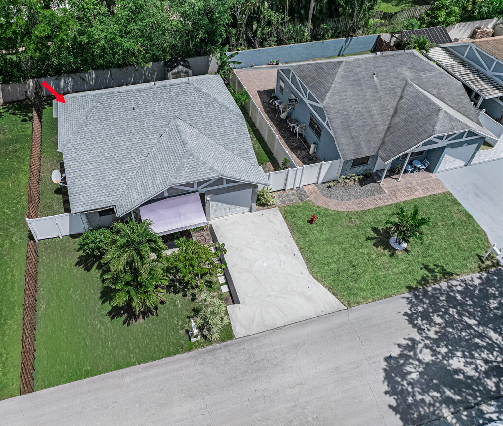 an aerial view of a house with a garden and plants
