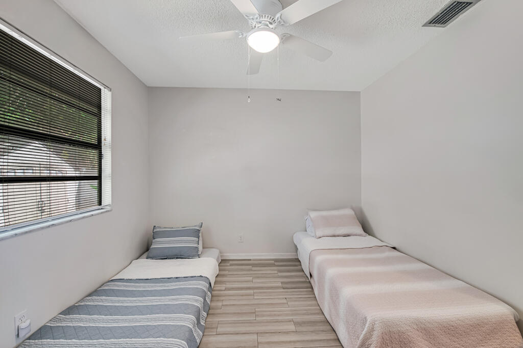 23428 Country Club Drive East Boca Raton, FL 33428 - Photo 23 of 32 a bedroom with a bed and window