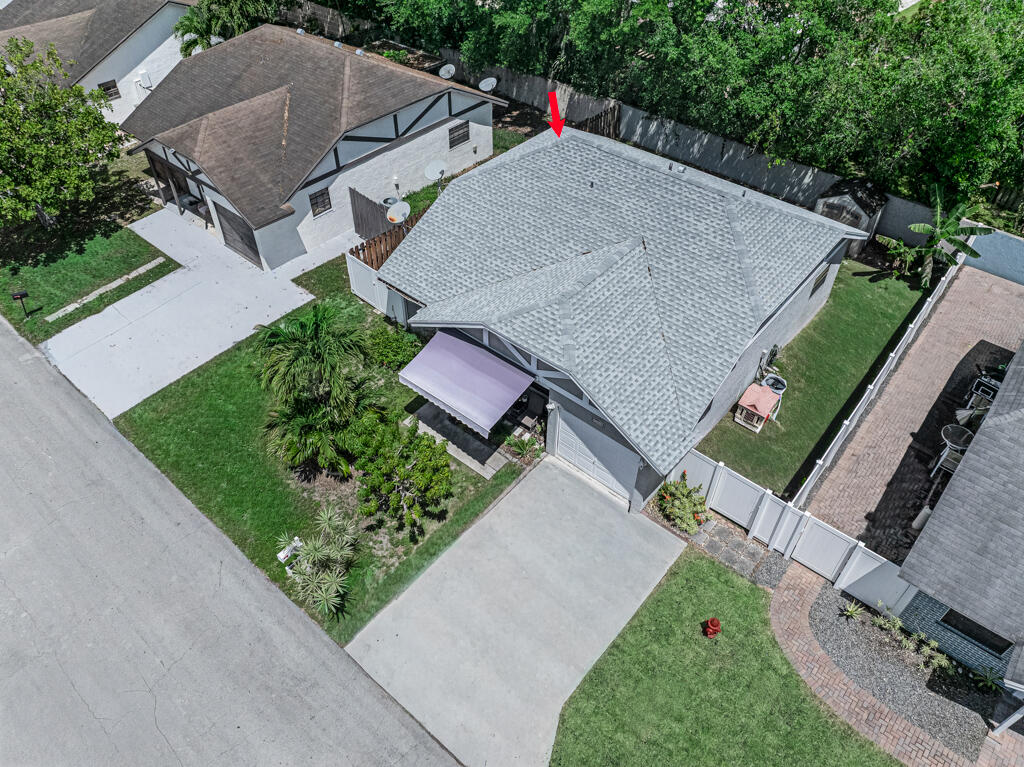 23428 Country Club Drive East Boca Raton, FL 33428 - Photo 3 of 32 an aerial view of a house with a garden and trees