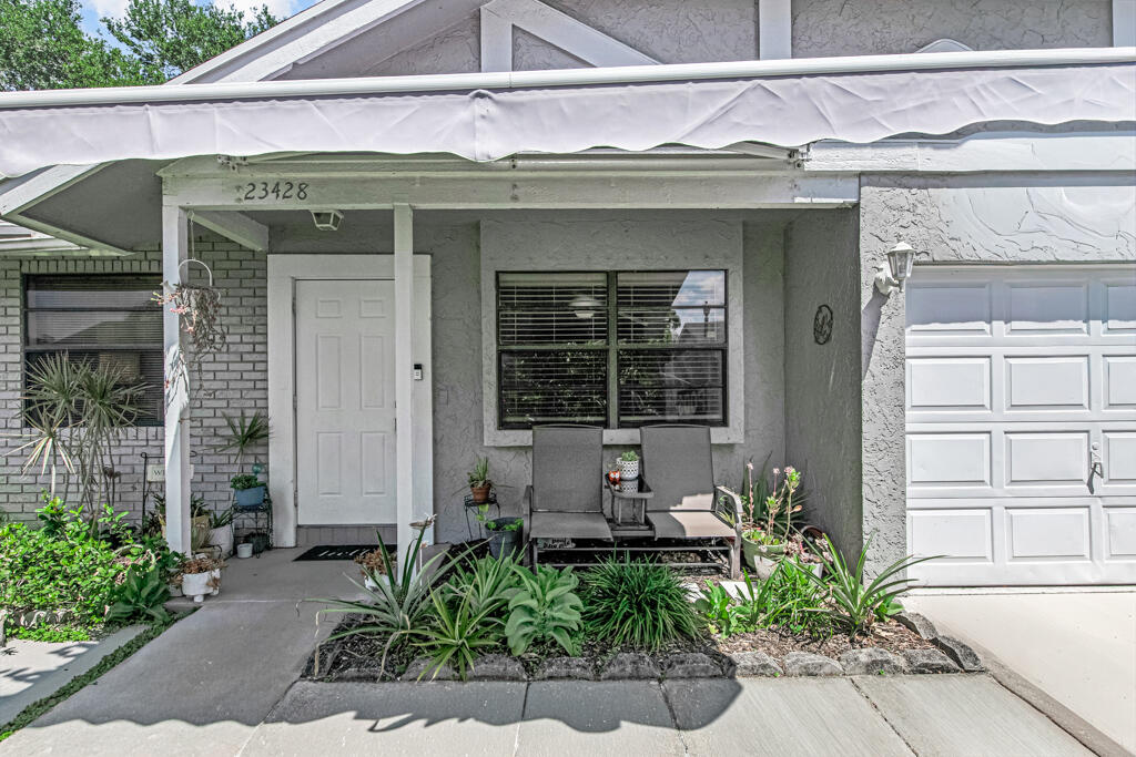 23428 Country Club Drive East Boca Raton, FL 33428 - Photo 6 of 32 a front view of a house