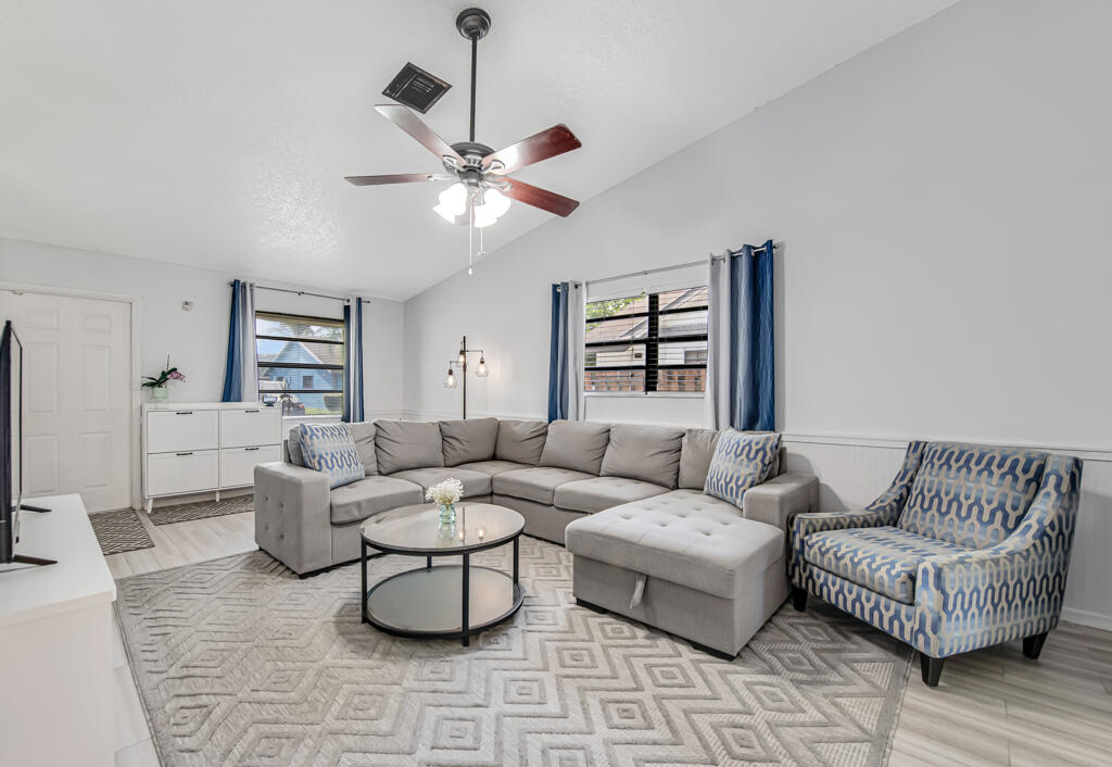 23428 Country Club Drive East Boca Raton, FL 33428 - Photo 8 of 32 a living room with furniture and a large window
