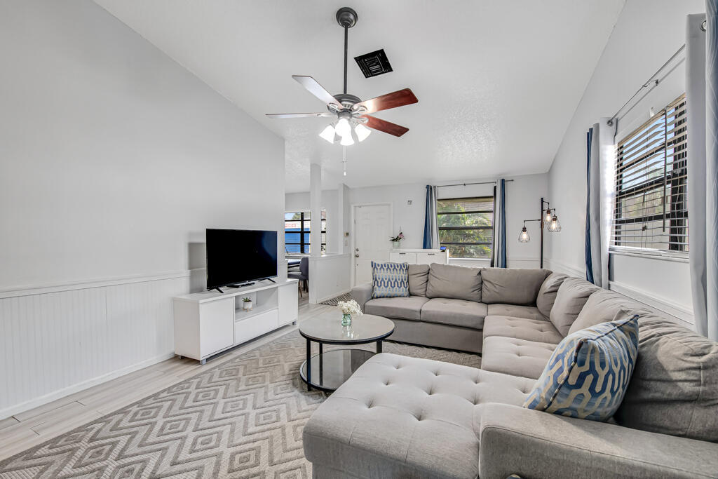 23428 Country Club Drive East Boca Raton, FL 33428 - Photo 10 of 32 a living room with furniture and a flat screen tv
