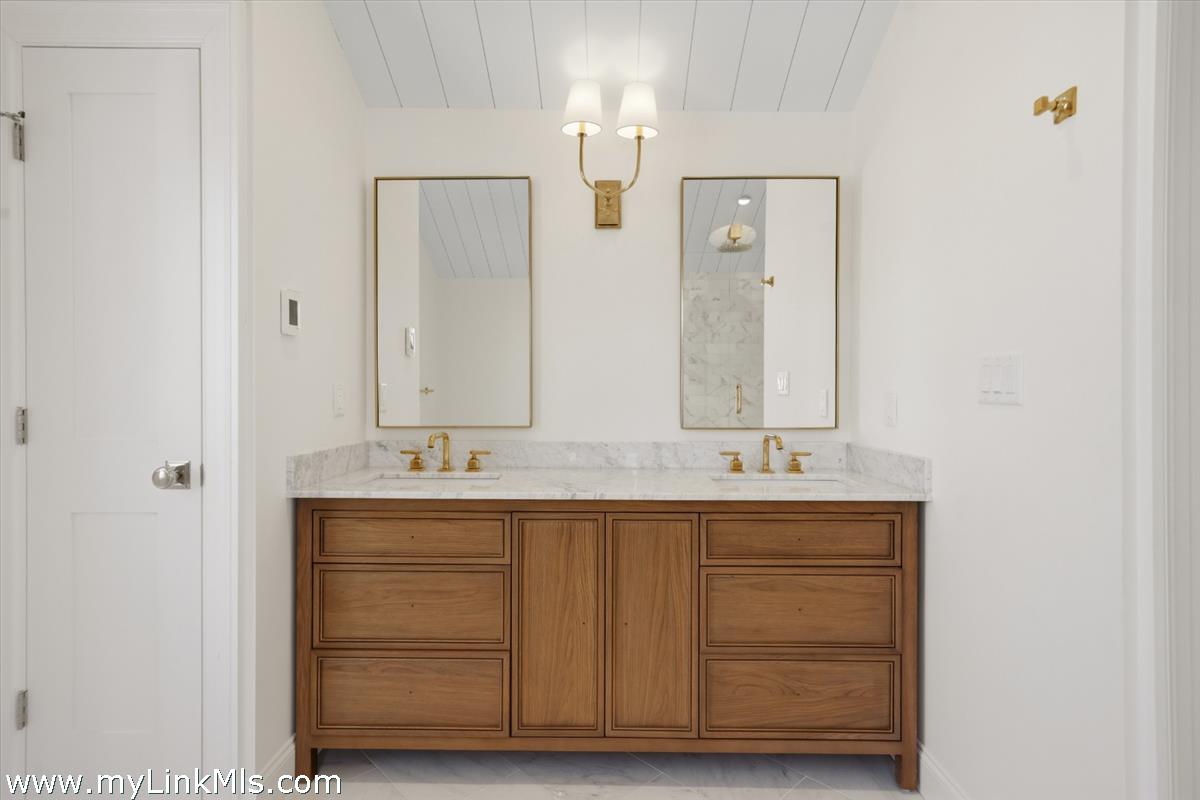 85 Orange Street Nantucket, MA 02554 - Photo 59 of 89 a bathroom with double sink and mirror