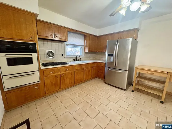 a kitchen with a refrigerator sink and cabinets