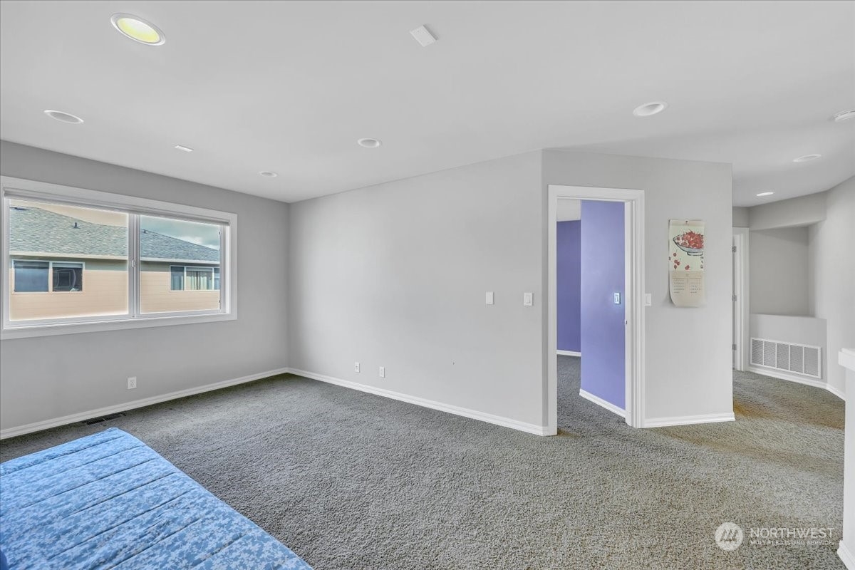 4604 Northeast 1st Court Renton, WA 98059 - Photo 25 of 40 a view of an empty room with wooden floor and a window