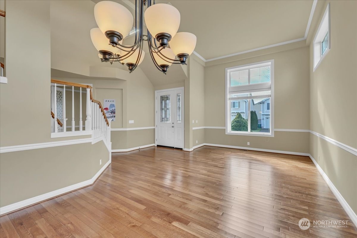 4604 Northeast 1st Court Renton, WA 98059 - Photo 8 of 40 a view of a livingroom with wooden floor and a window