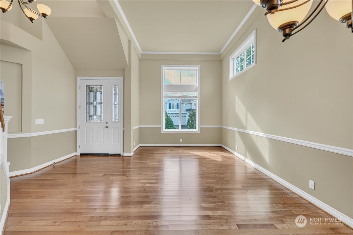 4604 Northeast 1st Court Renton, WA 98059 - Photo 9 of 40 a view of an empty room with wooden floor and a window