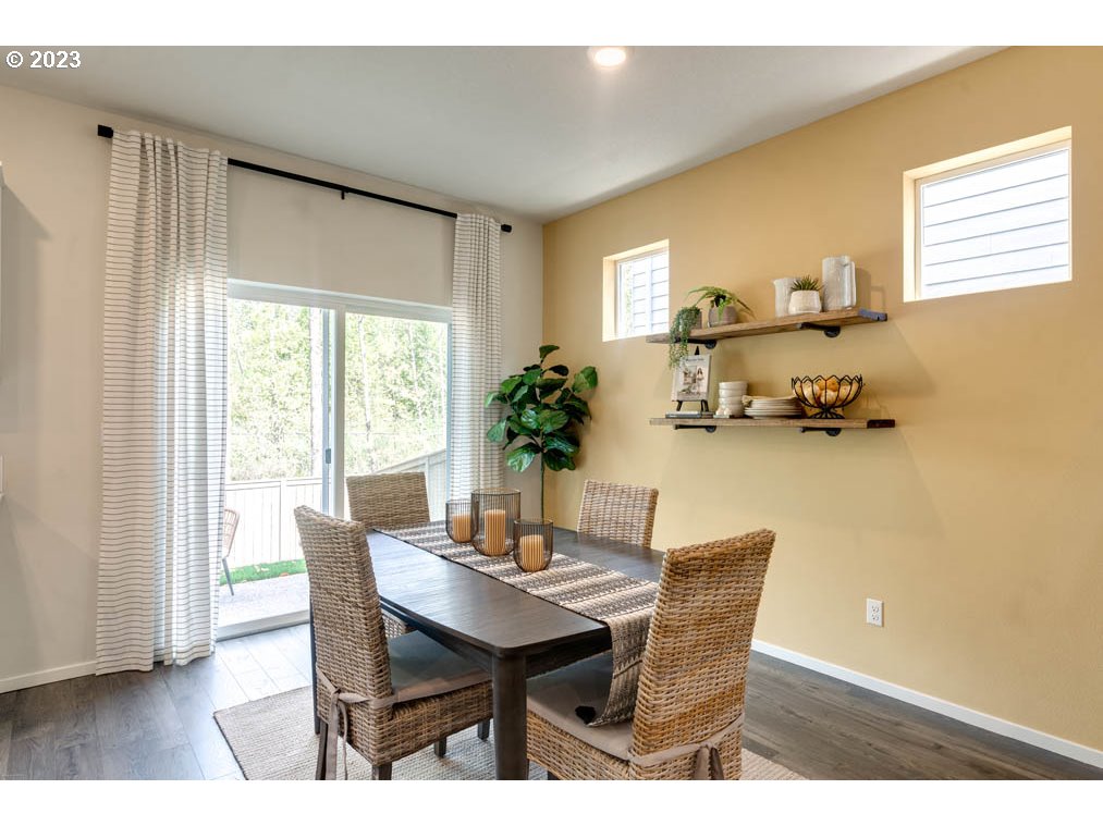 2021 Northwest 14th Street Battle Ground, WA 98604 - Photo 12 of 21 a view of a dining room with furniture and wooden floor