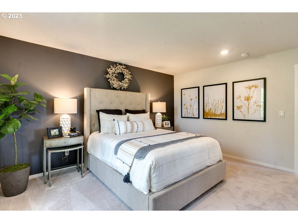 2021 Northwest 14th Street Battle Ground, WA 98604 - Photo 14 of 21 a bedroom with a large bed and a potted plant