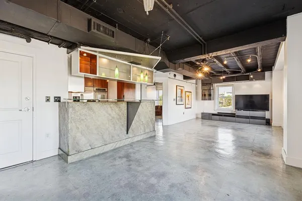 a kitchen with stainless steel appliances granite countertop a sink stove and microwave