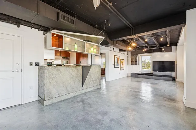 a kitchen with stainless steel appliances granite countertop a sink stove and microwave