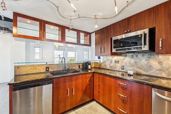 a bathroom with a tub a sink and a window