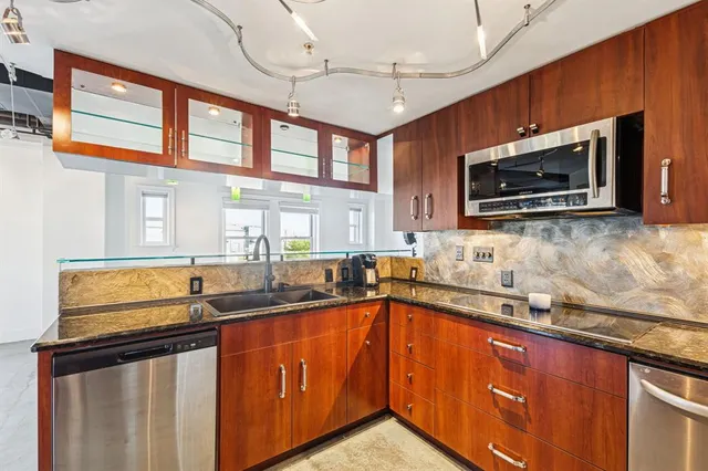 a bathroom with a tub a sink and a window