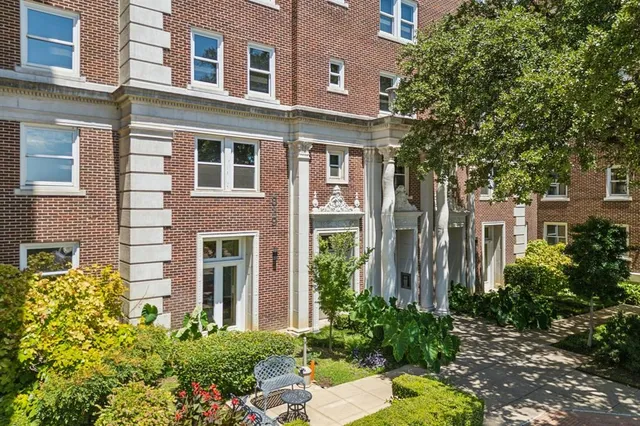 front view of a brick house with a yard
