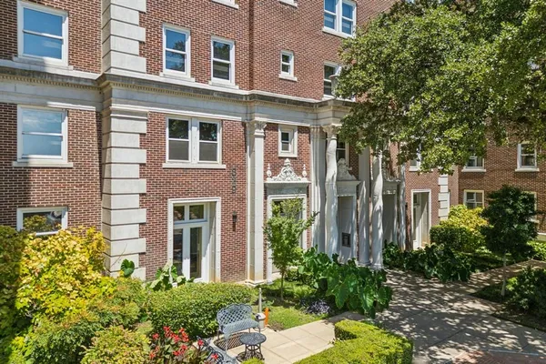 front view of a brick house with a yard
