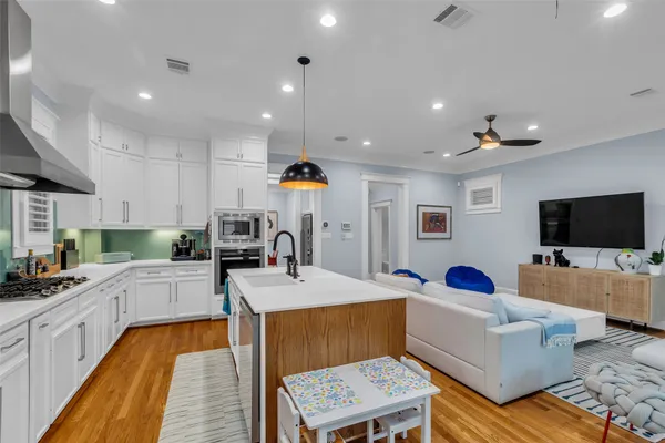 a large white kitchen with a large window