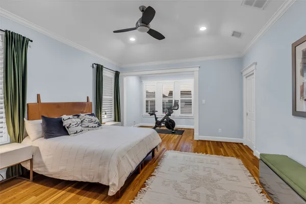 a bedroom with a large bed and a chandelier