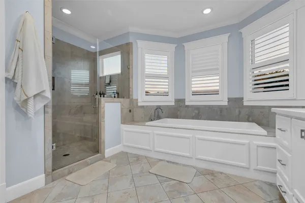 a spacious bathroom with a bathtub shower and sink