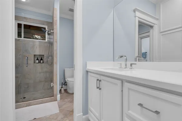 a bathroom with a shower sink and toilet