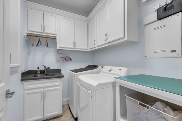 a utility room with sink dryer and washer