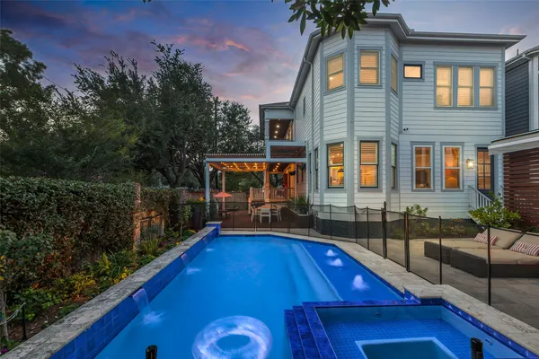a view of a swimming pool with a patio and a yard
