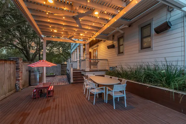 a patio with wooden floors and outdoor seating