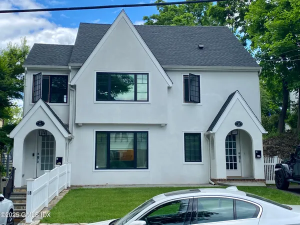 a front view of a house with garden