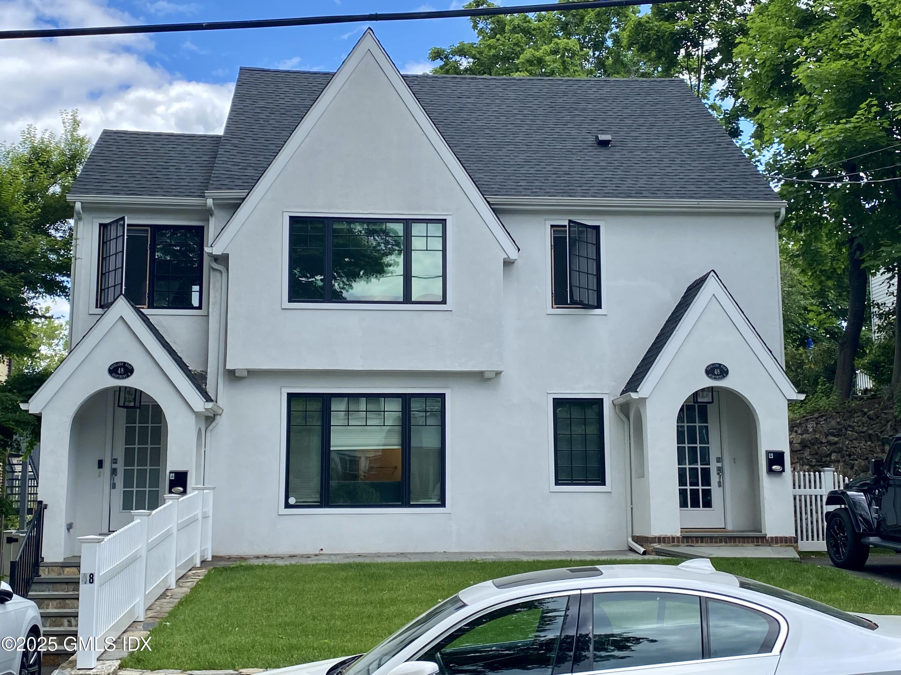 a front view of a house with garden