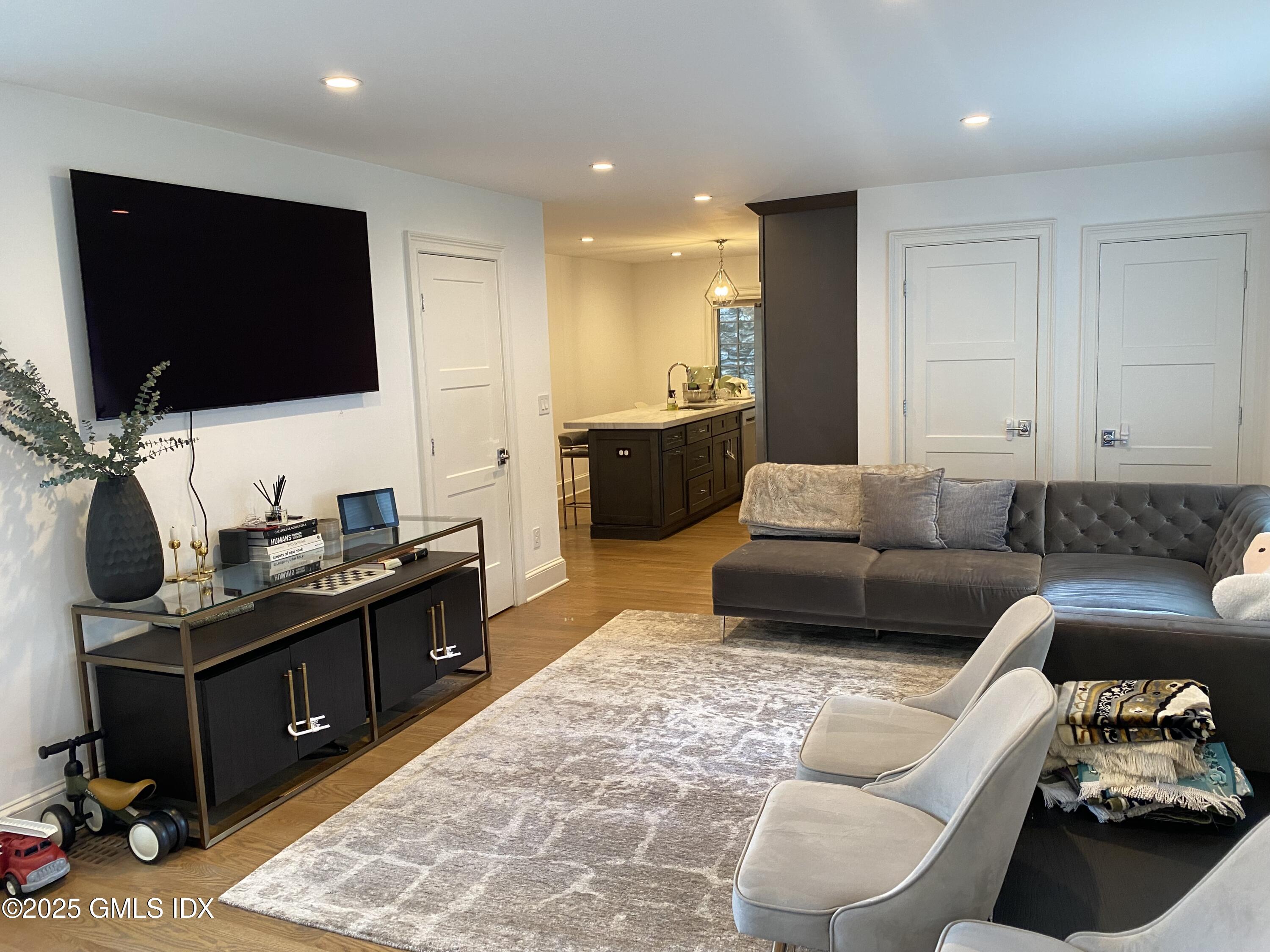 48 Richland Road Greenwich, CT 06830 - Photo 16 of 18 a living room with furniture and a flat screen tv