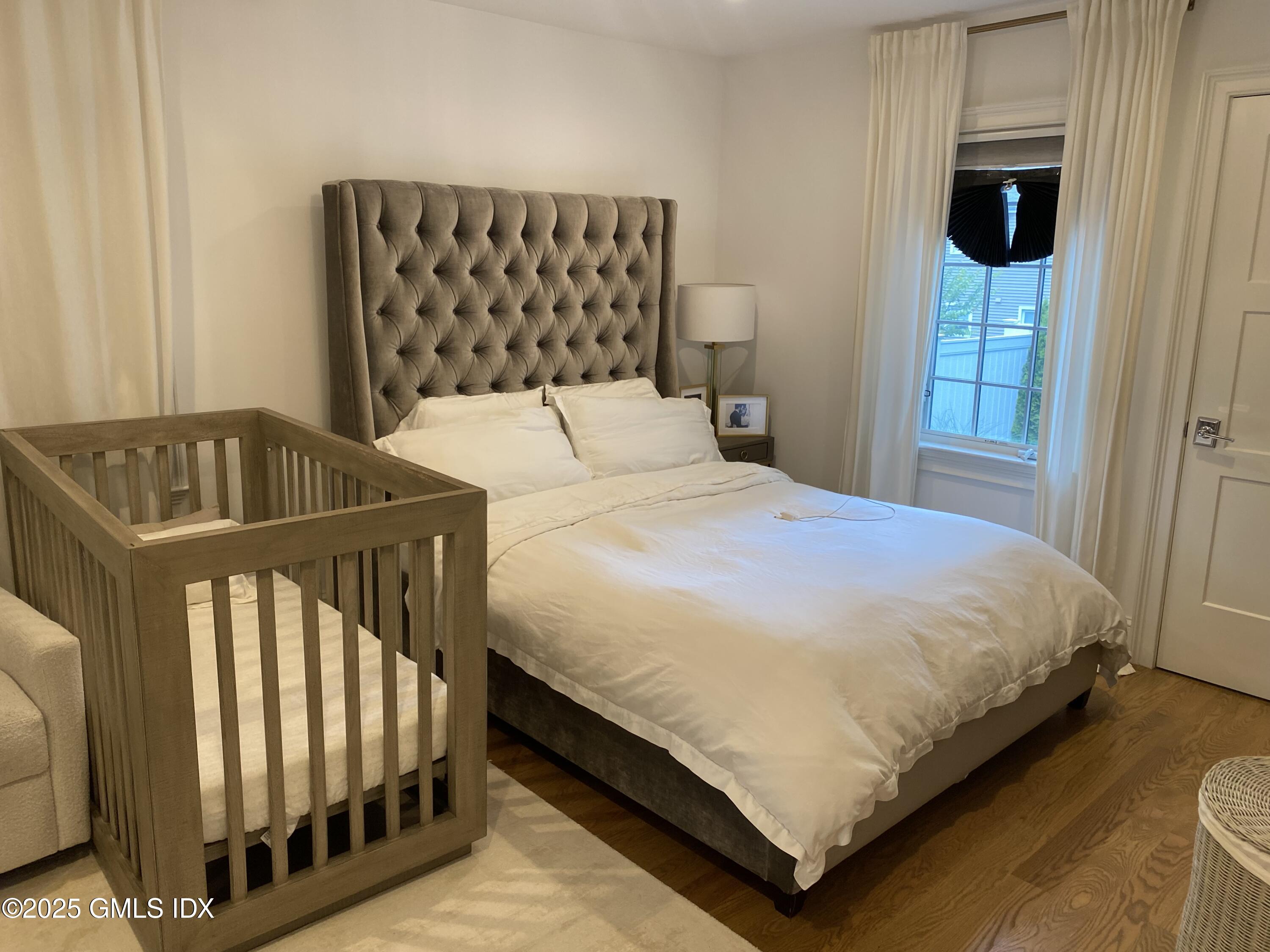 48 Richland Road Greenwich, CT 06830 - Photo 18 of 18 a bedroom with a bed and window