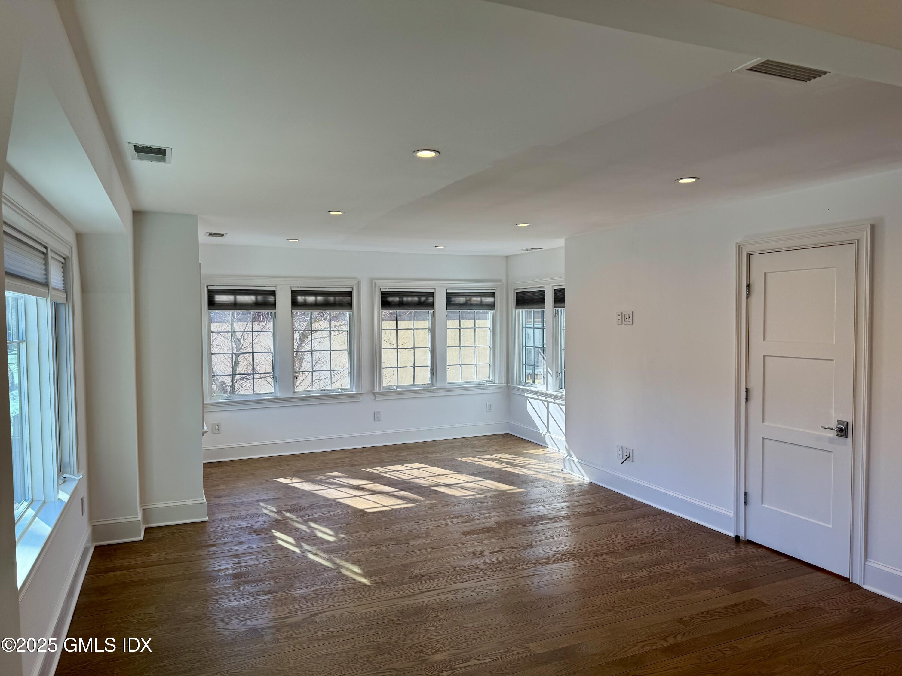 48 Richland Road Greenwich, CT 06830 - Photo 5 of 18 a view of empty room with wooden floor and fan