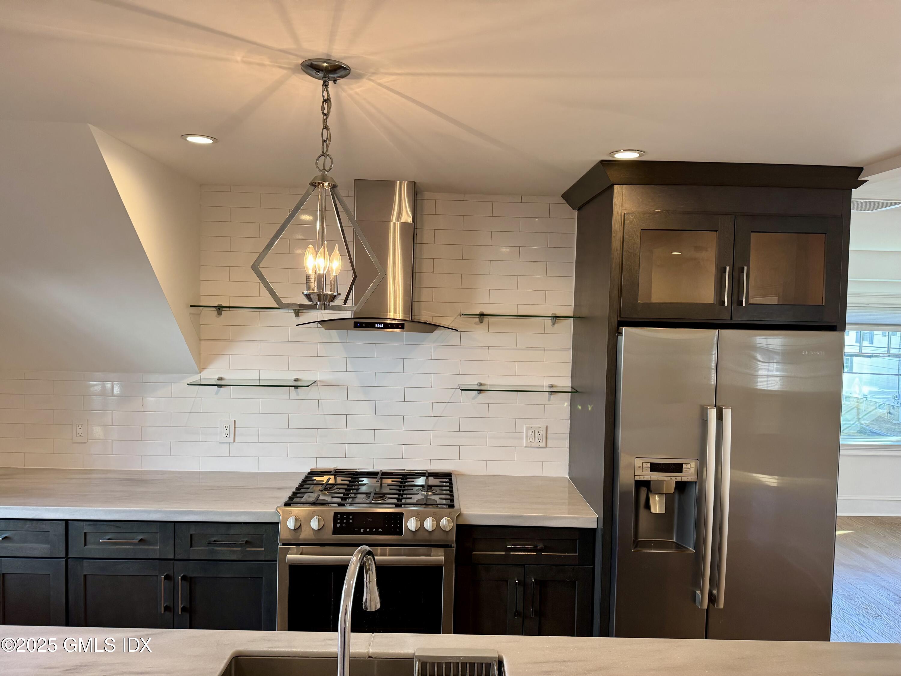 48 Richland Road Greenwich, CT 06830 - Photo 6 of 18 a kitchen with stainless steel appliances granite countertop a stove a refrigerator and a sink