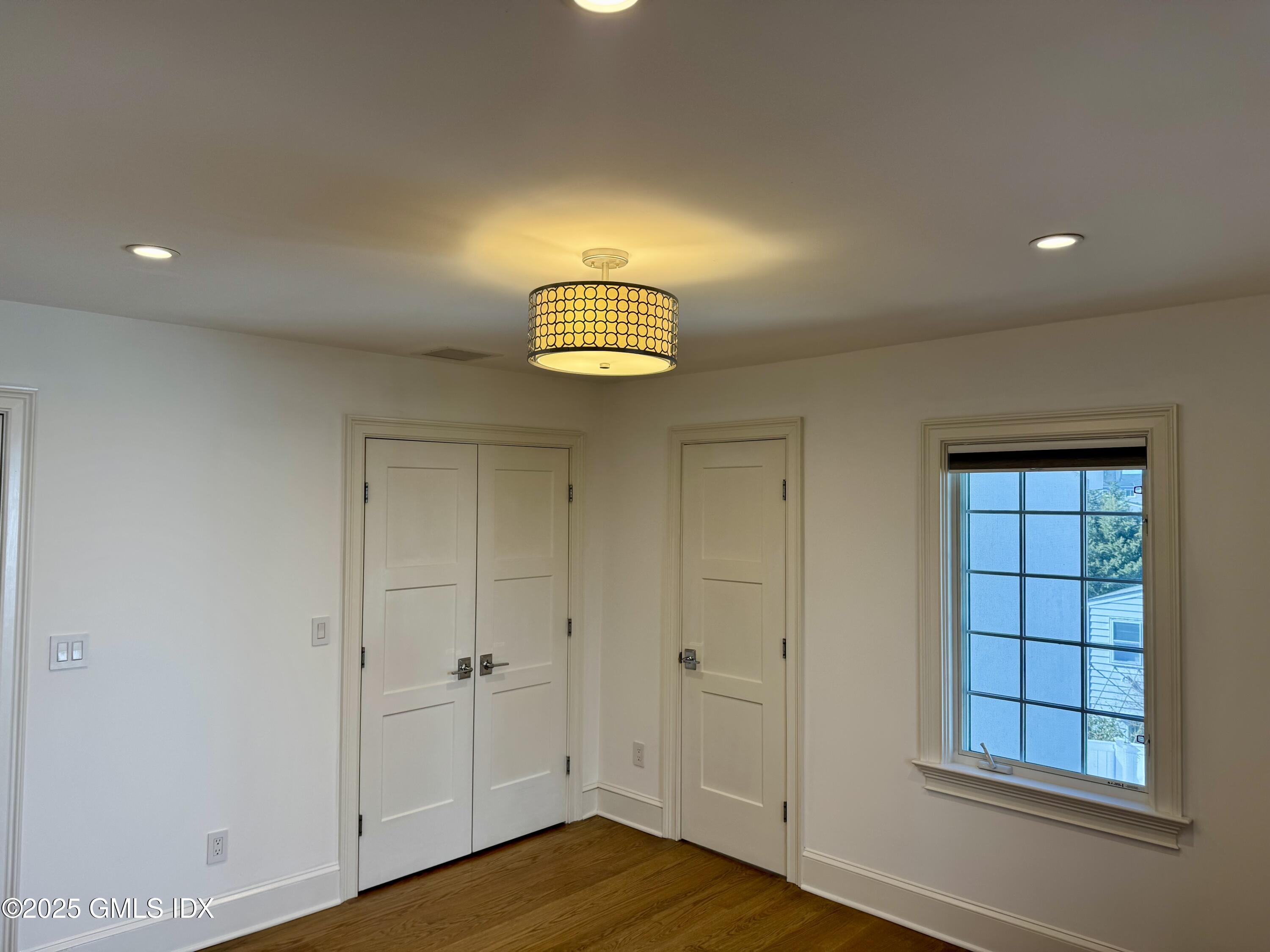 48 Richland Road Greenwich, CT 06830 - Photo 7 of 18 a view of empty room with window and wooden floor