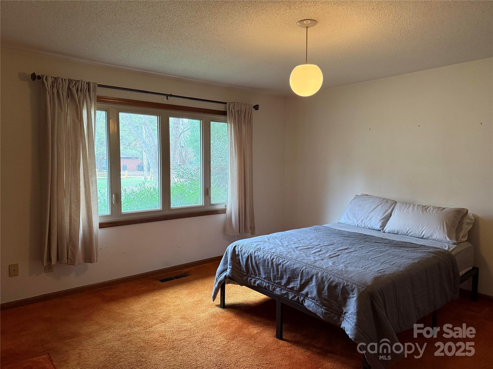 6102 Unity Lane Northwest Concord, NC 28027 - Photo 12 of 17 a bedroom with a bed and a window