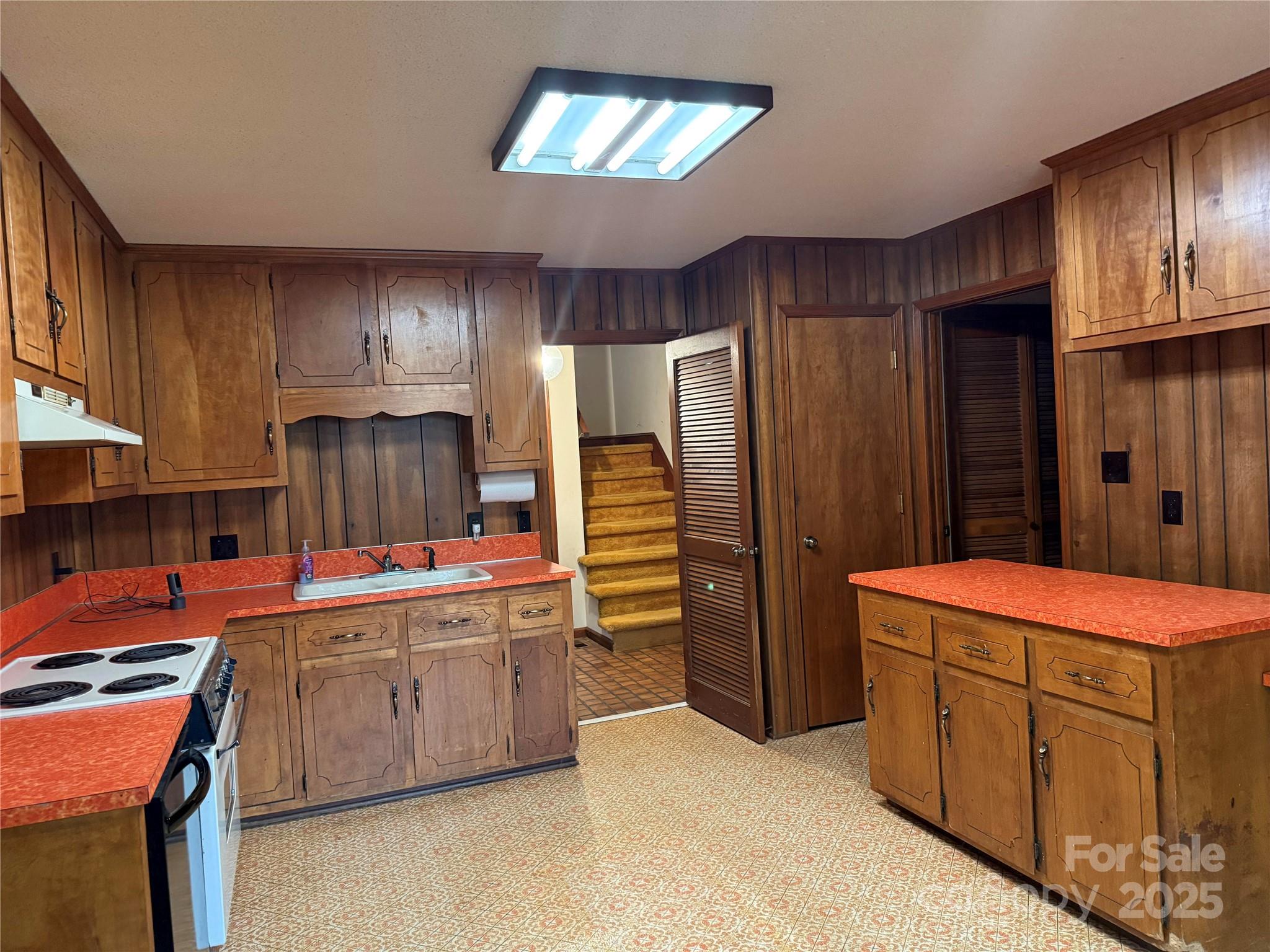 6102 Unity Lane Northwest Concord, NC 28027 - Photo 8 of 17 a kitchen with stainless steel appliances a stove refrigerator sink and cabinets