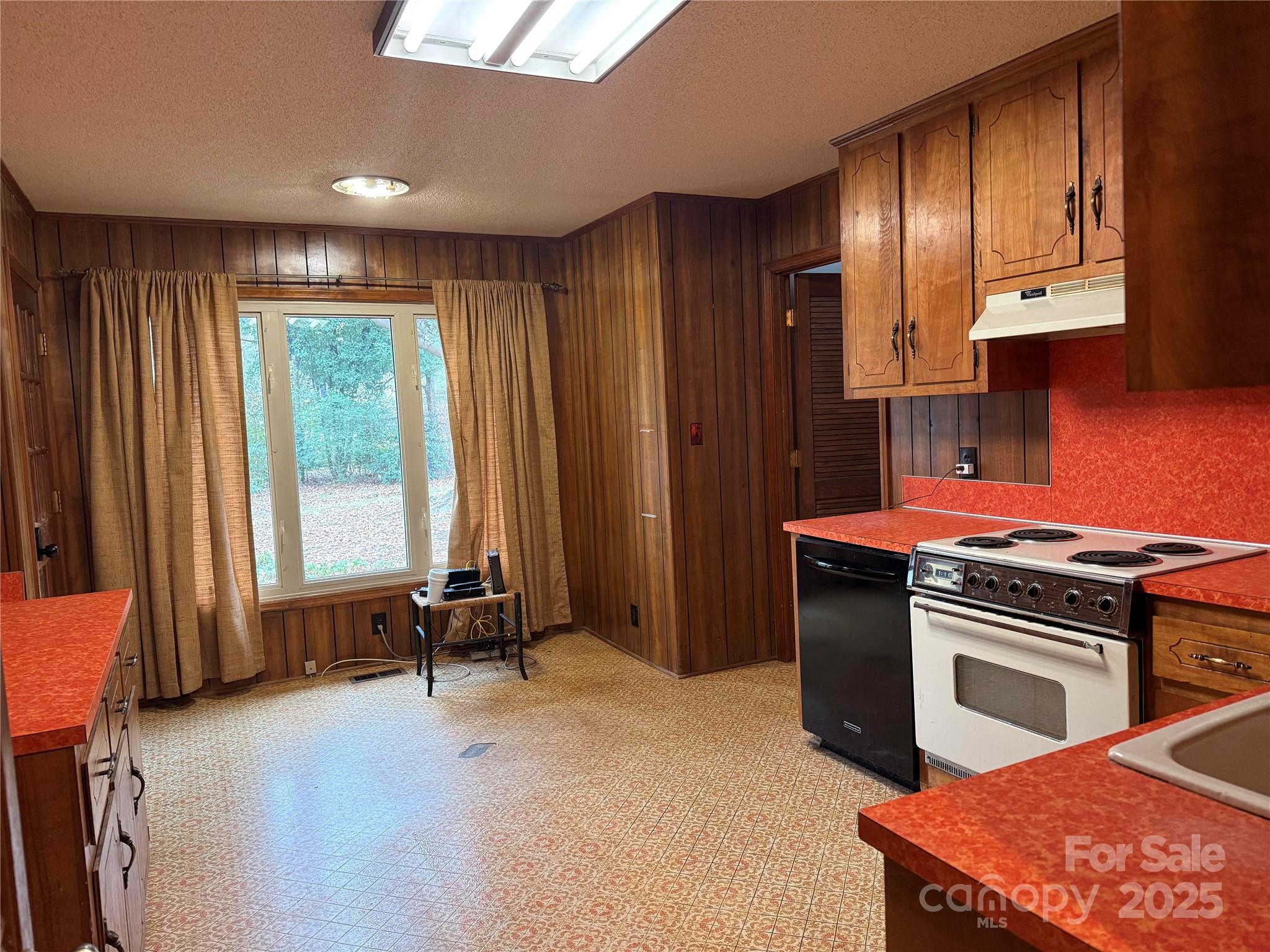 6102 Unity Lane Northwest Concord, NC 28027 - Photo 9 of 17 a kitchen with stainless steel appliances granite countertop a stove a sink and a refrigerator