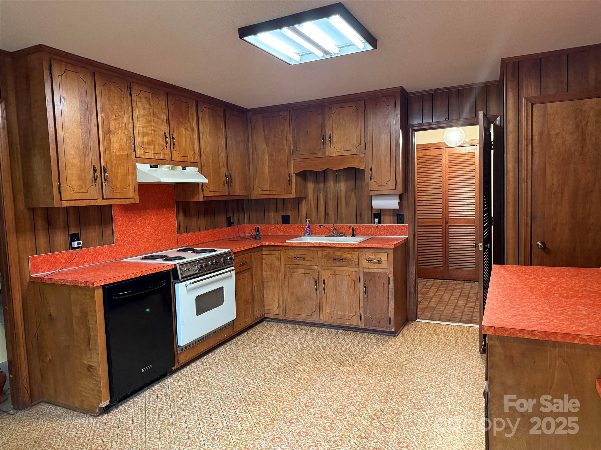 6102 Unity Lane Northwest Concord, NC 28027 - Photo 10 of 17 a kitchen with stainless steel appliances granite countertop a stove a refrigerator a sink dishwasher and wooden cabinets with wooden floor