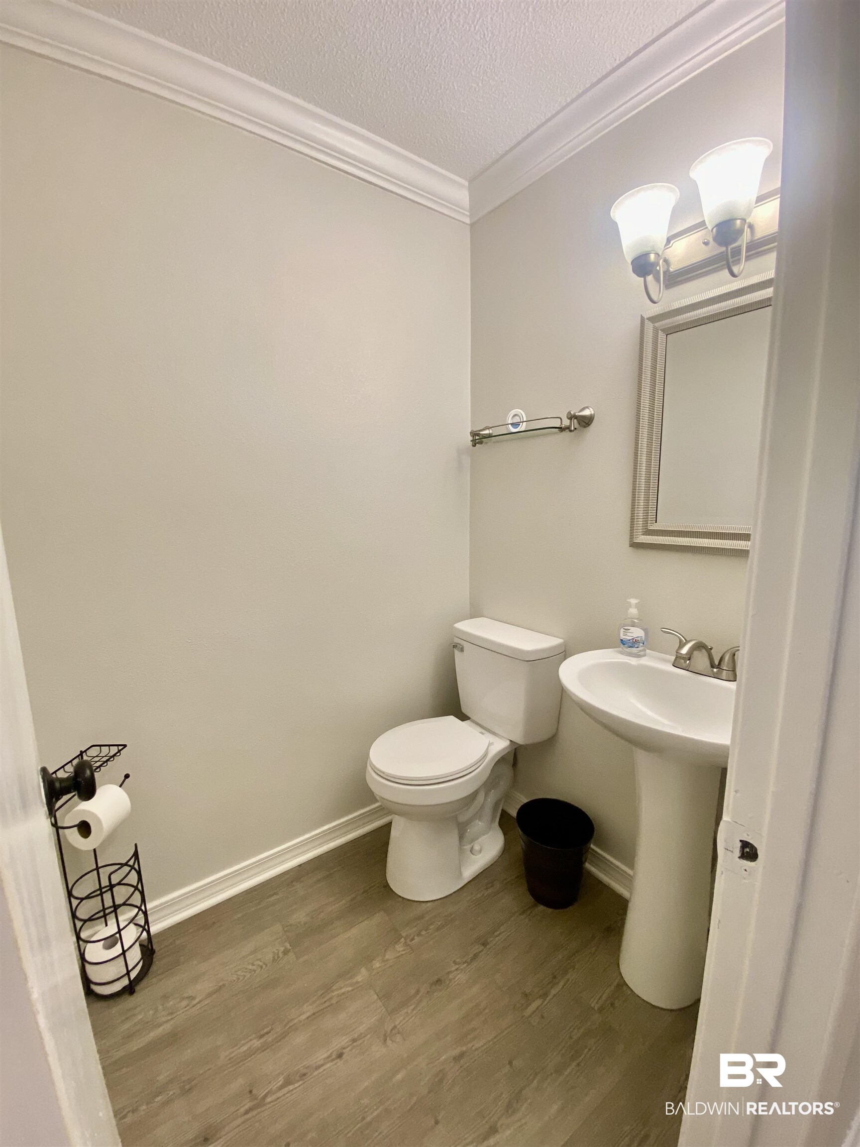 265 Azalea Drive Monroeville, AL 36460 - Photo 21 of 39 Bathroom with hardwood / wood-style floors, a textured ceiling, toilet, and ornamental molding