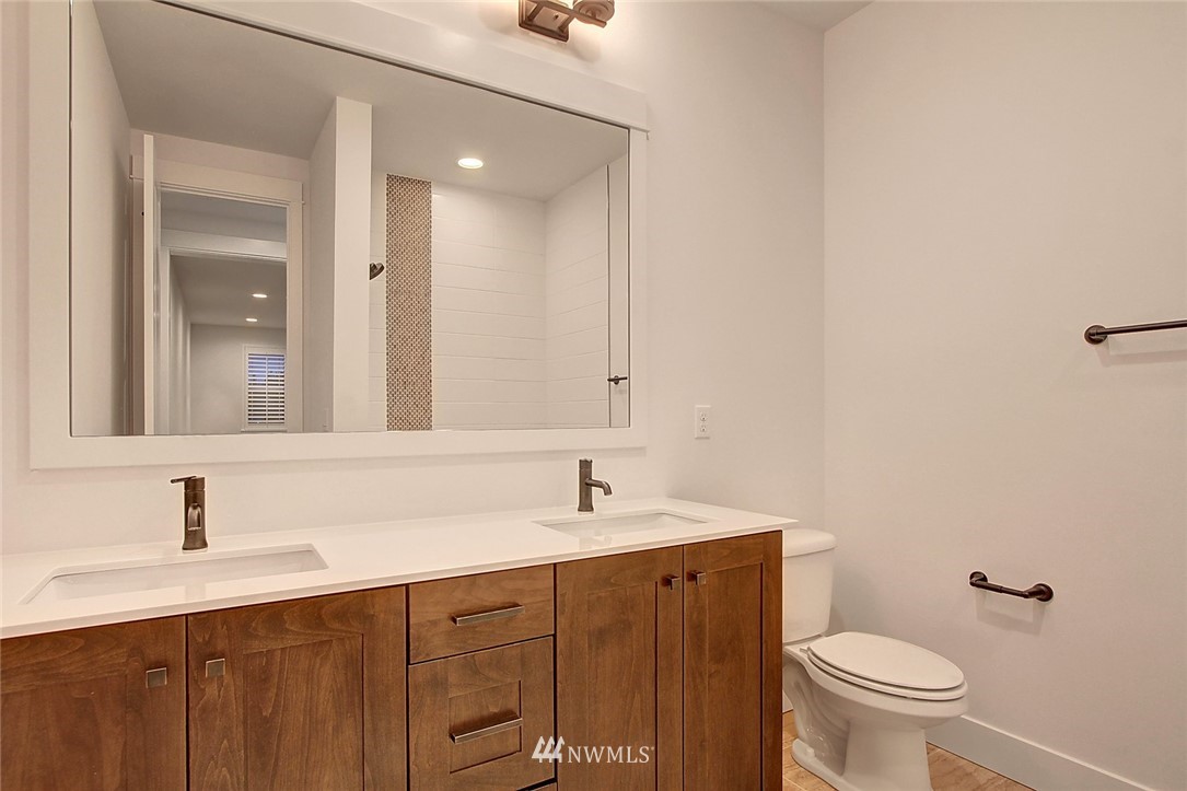 21638 35th Avenue Southeast, Unit 21 Bothell, WA 98021 - Photo 11 of 25 a bathroom with a toilet a sink and mirror