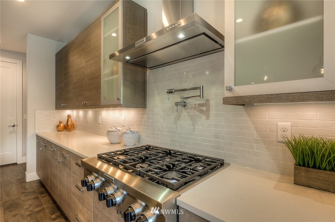 21638 35th Avenue Southeast, Unit 21 Bothell, WA 98021 - Photo 13 of 25 a kitchen with sink stove and cabinets